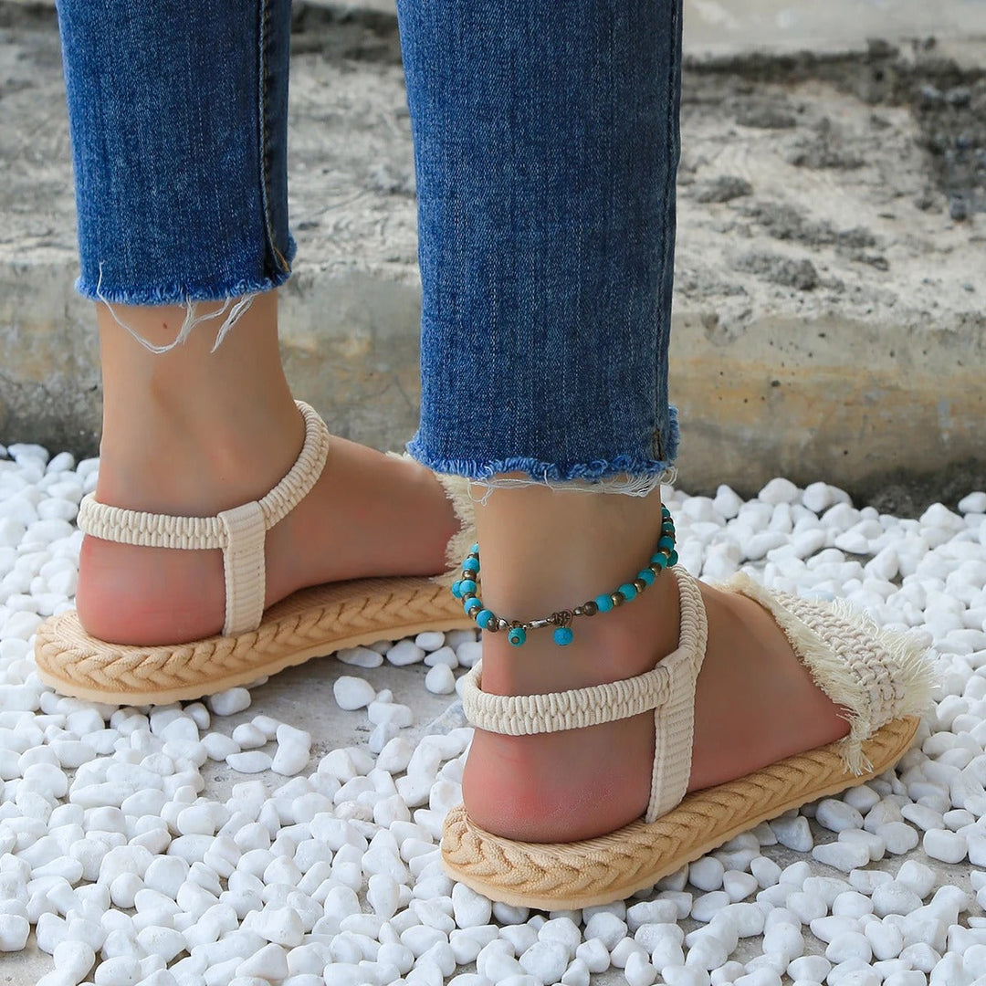 Damensandalen für den Sommer | Flacher Absatz | Trendige beigefarbene Schuhe mit Quasten-Luzern Mode